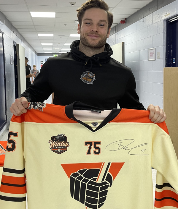 The image shows a match worn jersey being offered as a prize in an ice hockey raffle